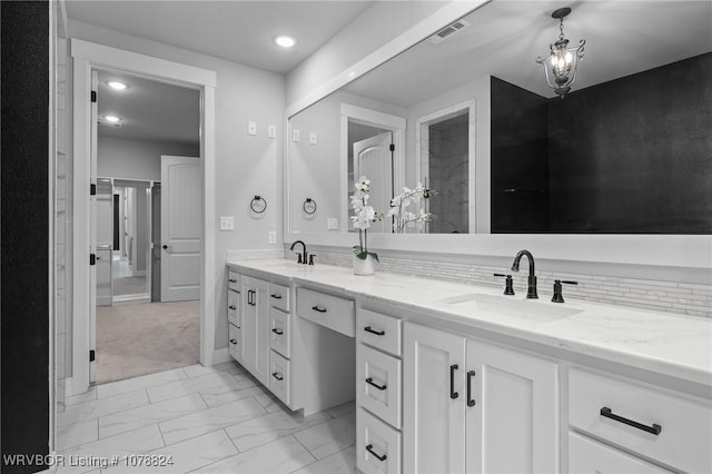 bathroom featuring vanity and a notable chandelier