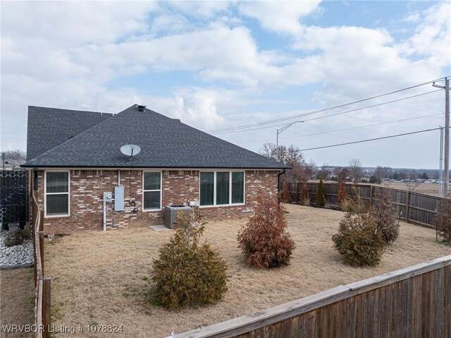 rear view of house featuring cooling unit