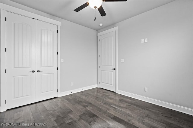 unfurnished bedroom with ceiling fan, dark hardwood / wood-style flooring, and a closet