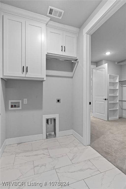 laundry area featuring cabinets, hookup for a washing machine, and hookup for an electric dryer