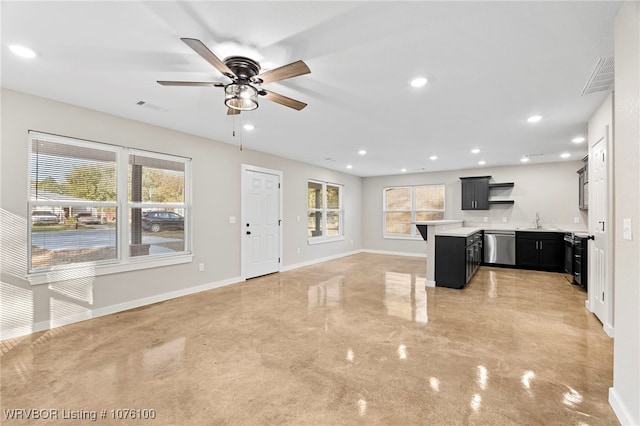 kitchen with ceiling fan, a center island, stainless steel dishwasher, and sink