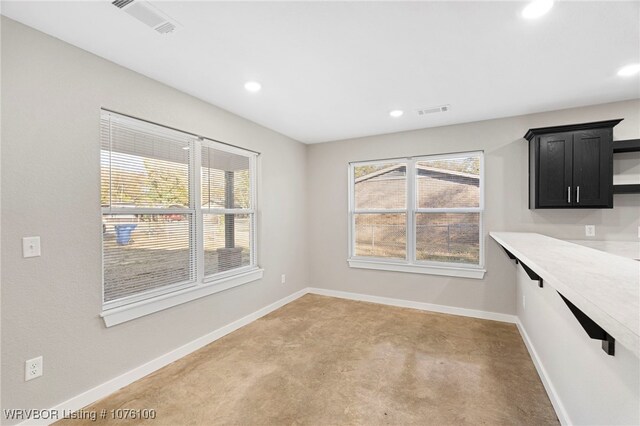 unfurnished dining area featuring carpet