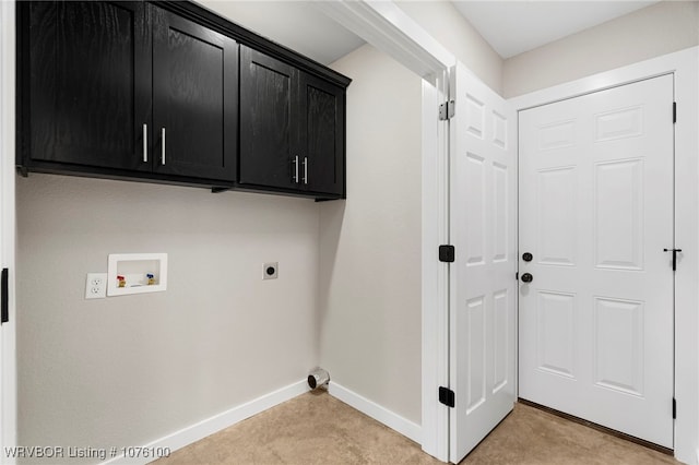 laundry room featuring electric dryer hookup, cabinets, light carpet, and hookup for a washing machine