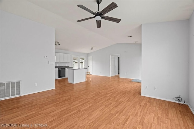 unfurnished living room featuring light wood-type flooring, visible vents, vaulted ceiling, and ceiling fan