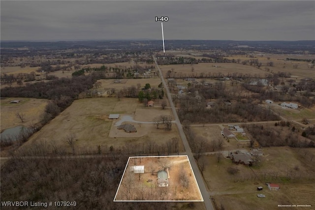 birds eye view of property with a rural view