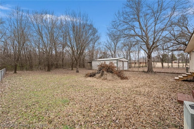 view of yard with fence and an outdoor structure