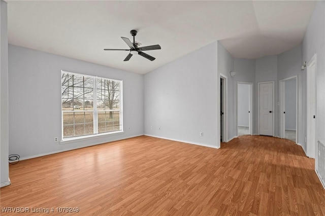 empty room with light wood-type flooring, ceiling fan, and baseboards