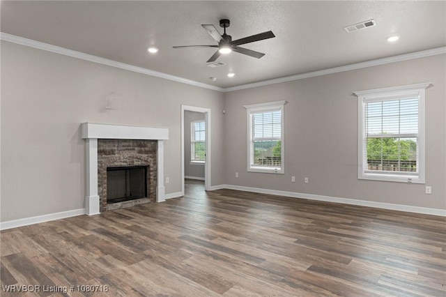 unfurnished living room featuring visible vents, wood finished floors, a ceiling fan, and ornamental molding