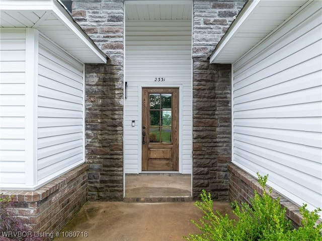 doorway to property with stone siding