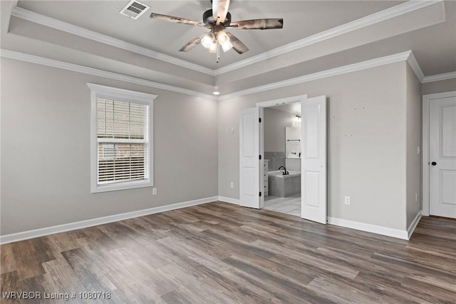 unfurnished bedroom with visible vents, wood finished floors, baseboards, and ornamental molding
