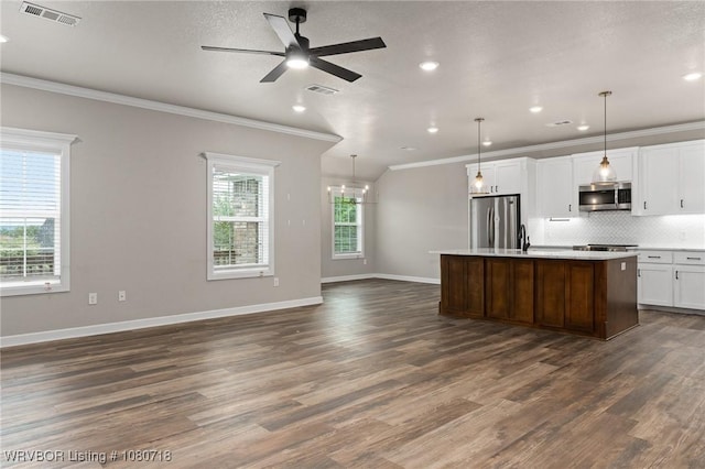 kitchen featuring ornamental molding, stainless steel appliances, open floor plan, and visible vents