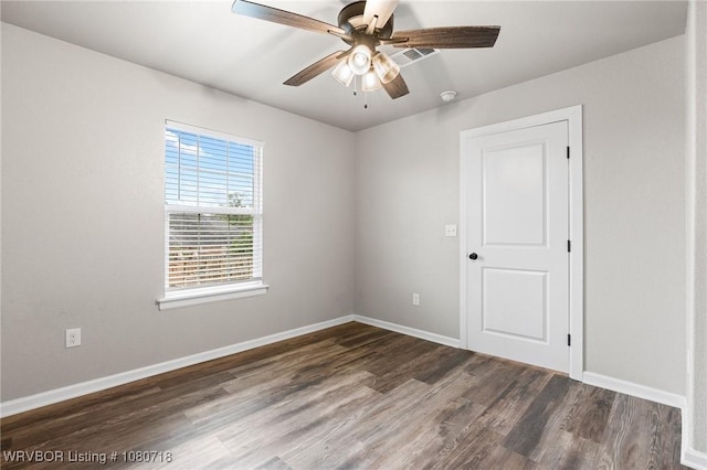 empty room with ceiling fan, baseboards, and wood finished floors