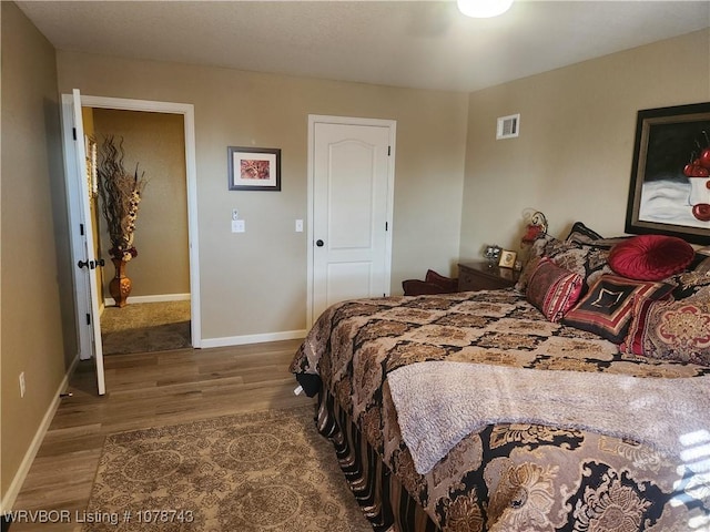 bedroom with hardwood / wood-style flooring