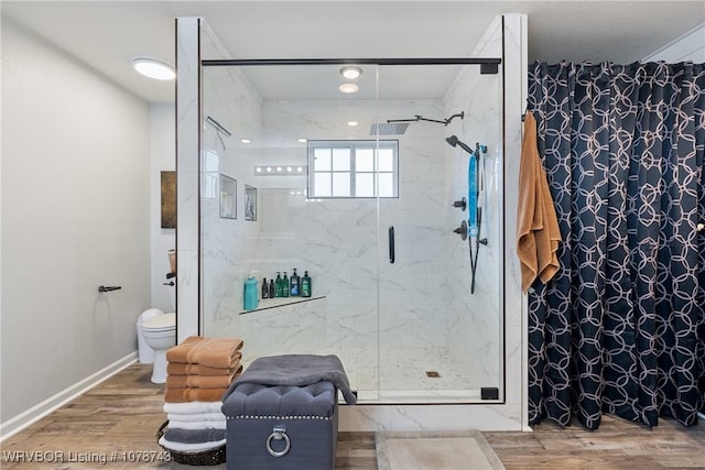 bathroom with walk in shower, hardwood / wood-style floors, and toilet