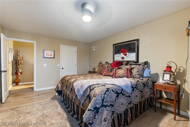 bedroom featuring light hardwood / wood-style flooring and ceiling fan