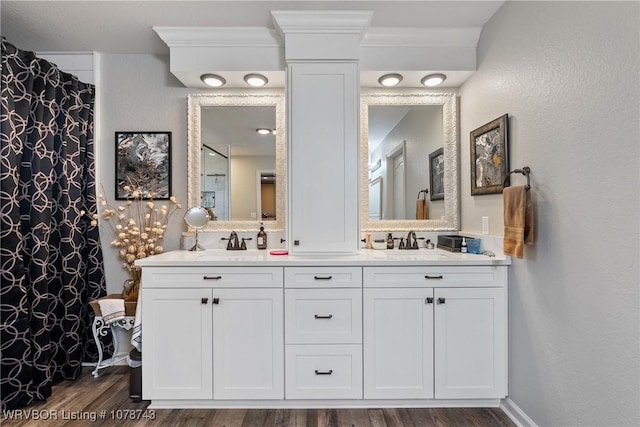 bathroom with hardwood / wood-style flooring and vanity