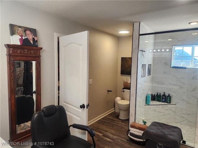 bathroom with toilet, hardwood / wood-style floors, and a shower with shower door