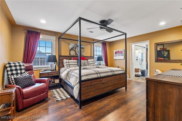 bedroom featuring multiple windows, ensuite bathroom, and dark wood-type flooring