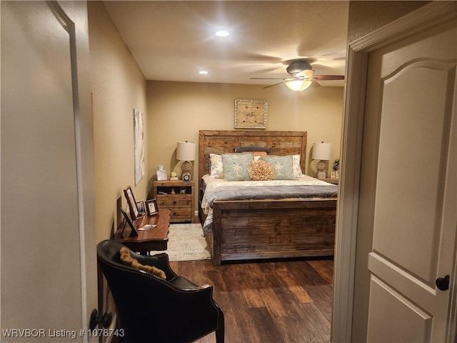 bedroom with dark hardwood / wood-style floors and ceiling fan