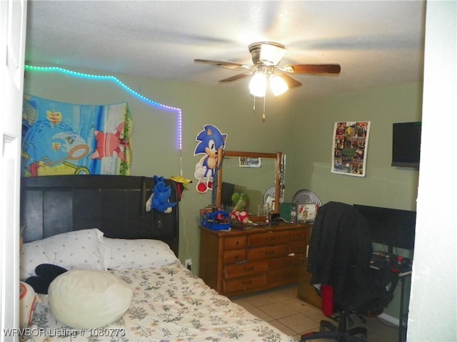 tiled bedroom featuring ceiling fan