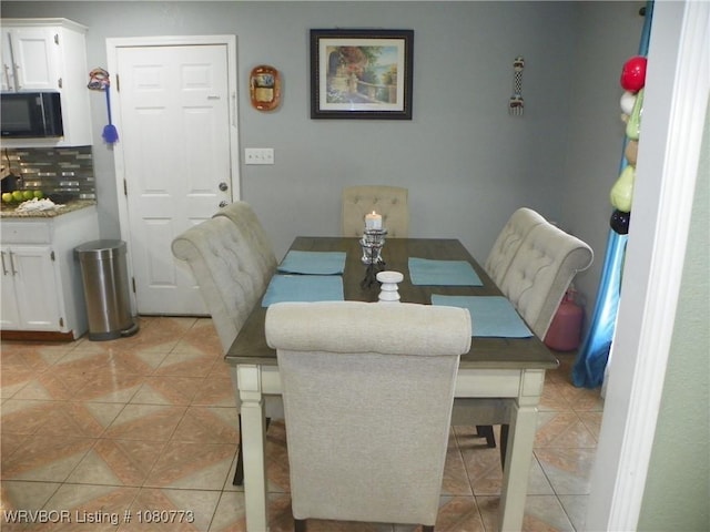dining room featuring light tile patterned flooring