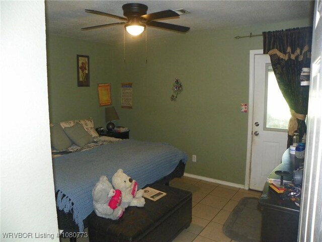 bedroom with visible vents, a ceiling fan, and light tile patterned floors