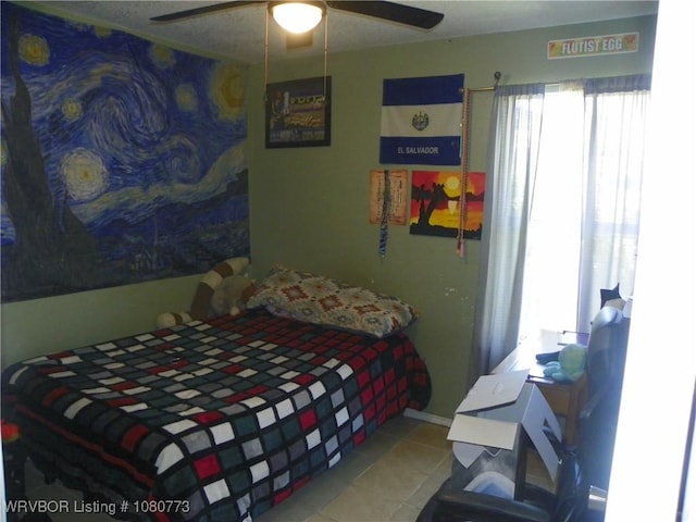 tiled bedroom featuring a ceiling fan