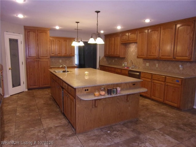 kitchen featuring sink, light stone countertops, an island with sink, decorative light fixtures, and stainless steel dishwasher