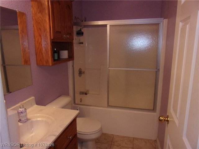 full bathroom with toilet, vanity, combined bath / shower with glass door, and tile patterned flooring