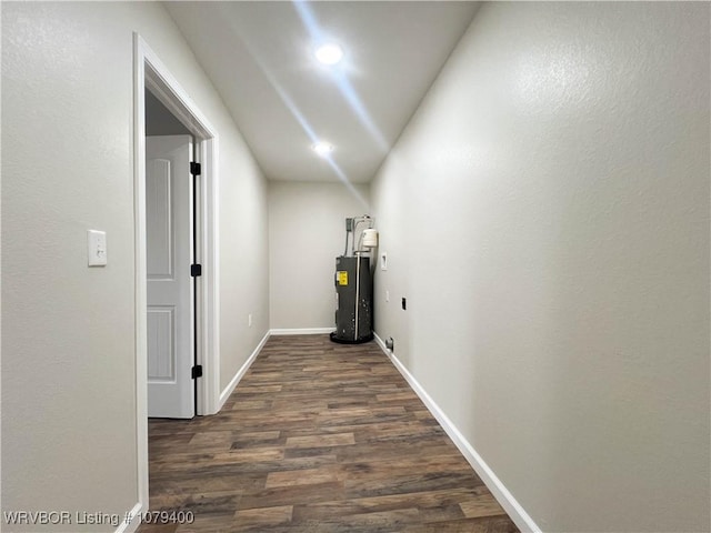 corridor with recessed lighting, gas water heater, baseboards, and dark wood-style flooring