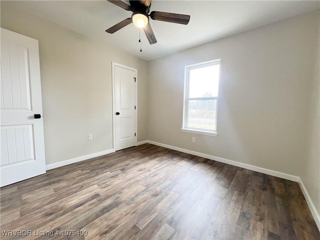 unfurnished room with ceiling fan, baseboards, and wood finished floors