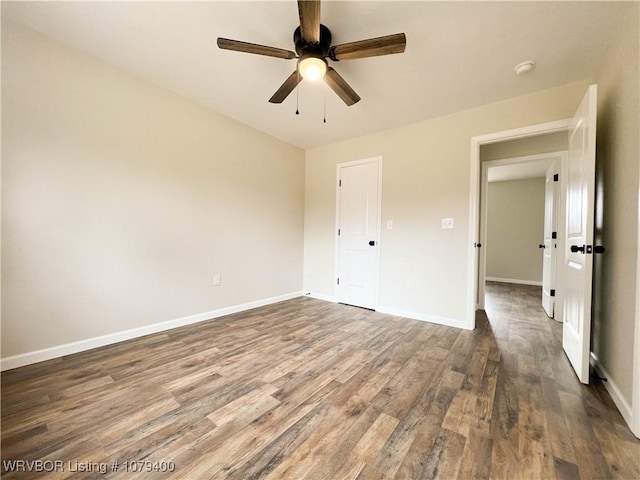 unfurnished bedroom featuring wood finished floors, a ceiling fan, and baseboards