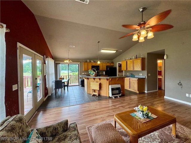 11739 282nd Hwy, Mountainburg, AR 72946 - living room with dark wood-type flooring, french doors, a ceiling fan, and high vaulted ceiling