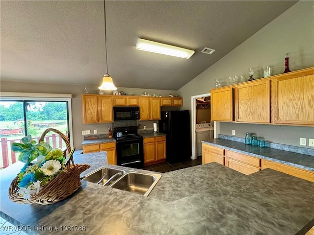 11739 282nd Hwy, Mountainburg, AR 72946 - kitchen with black appliances, independent washer and dryer, a textured ceiling, lofted ceiling, and dark countertops