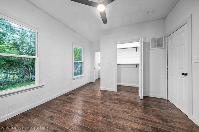 unfurnished bedroom with baseboards, a ceiling fan, wood finished floors, and visible vents
