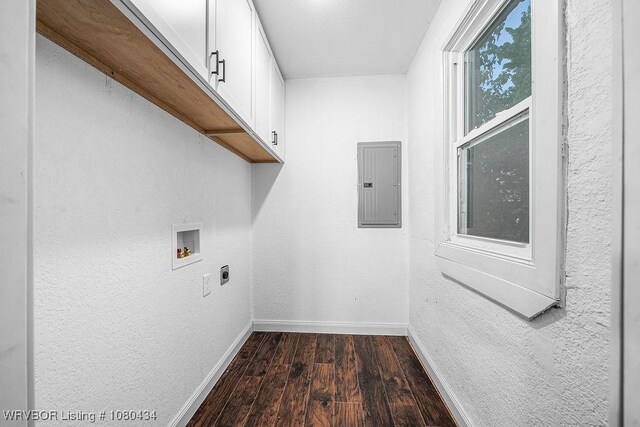laundry area with electric dryer hookup, electric panel, cabinet space, baseboards, and dark wood-style floors
