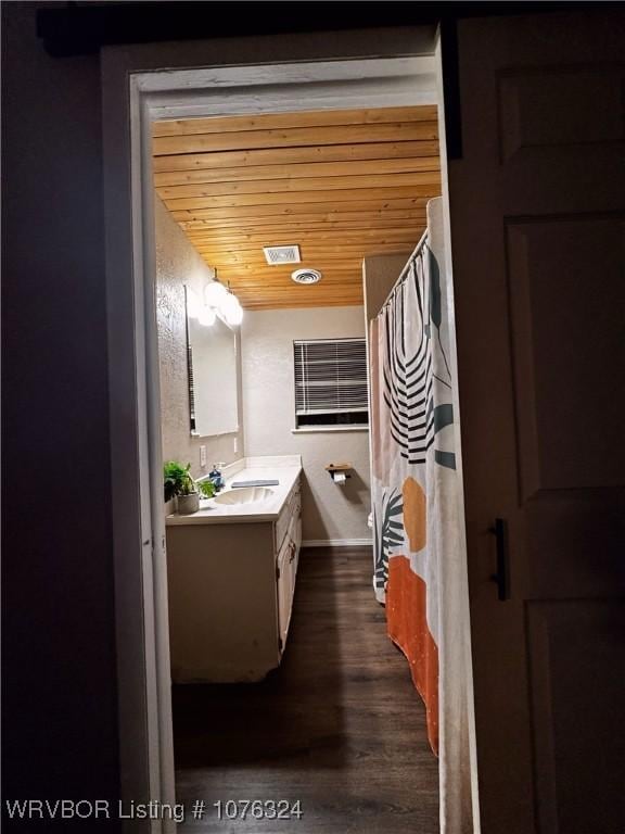 bathroom with hardwood / wood-style flooring, vanity, and wooden ceiling