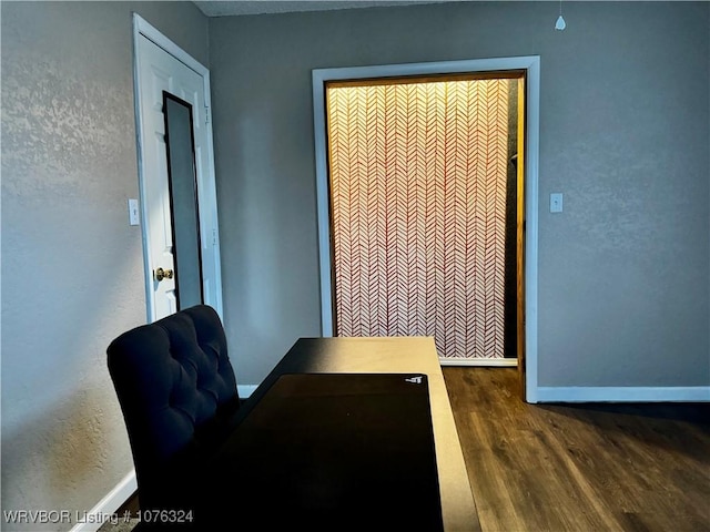 home office with dark hardwood / wood-style floors