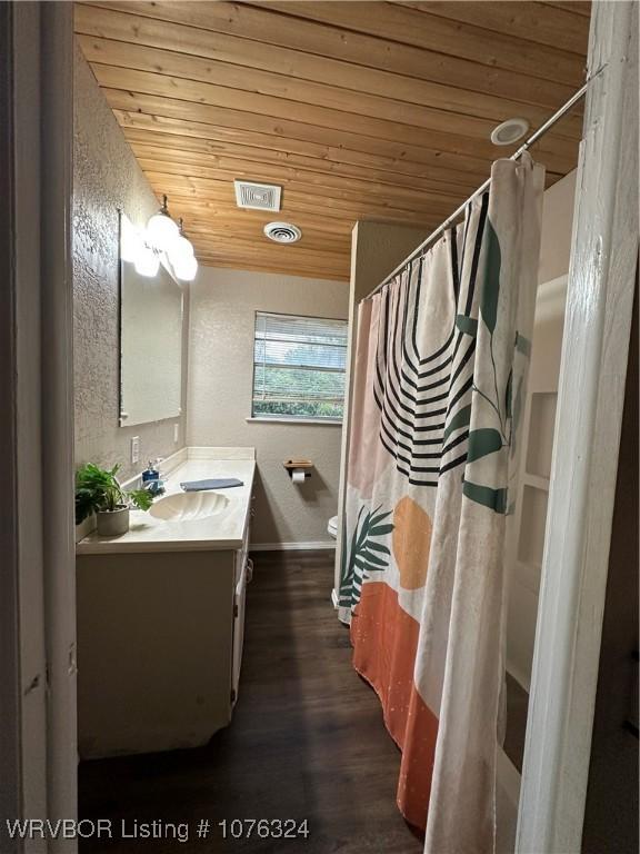 bathroom featuring hardwood / wood-style floors, vanity, toilet, and wood ceiling