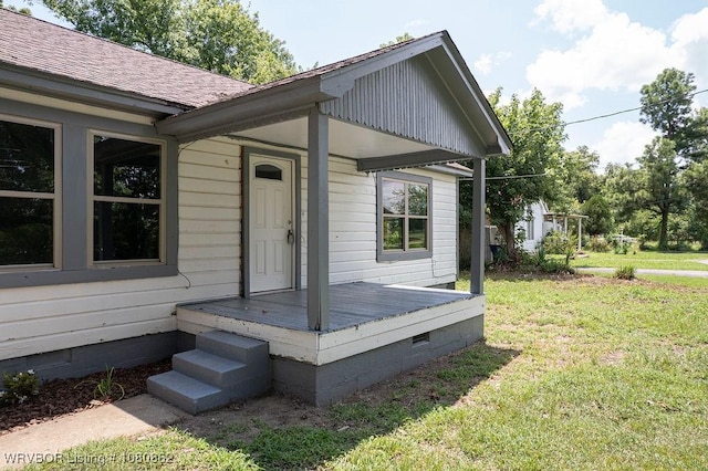 view of side of home with crawl space, a yard, a shingled roof, and a deck