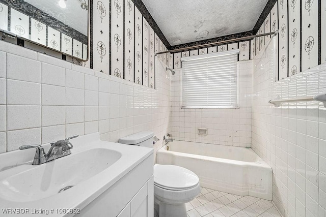full bath featuring tile walls, wallpapered walls, toilet,  shower combination, and tile patterned floors