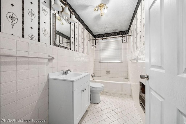 bathroom with wallpapered walls, toilet, tile walls, tile patterned floors, and  shower combination