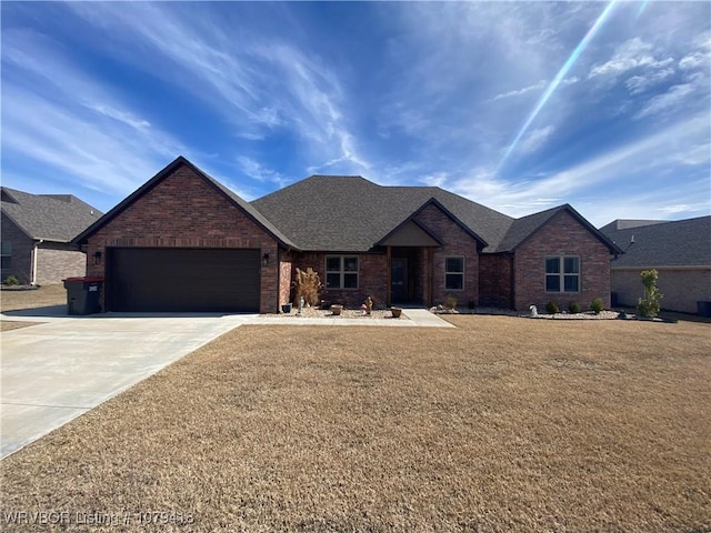 ranch-style home featuring concrete driveway, brick siding, a front lawn, and an attached garage