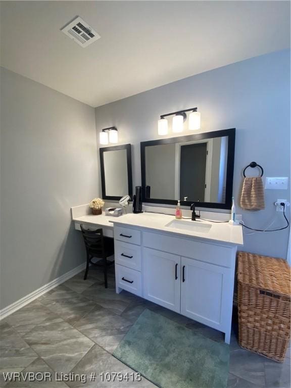 bathroom featuring vanity, visible vents, and baseboards