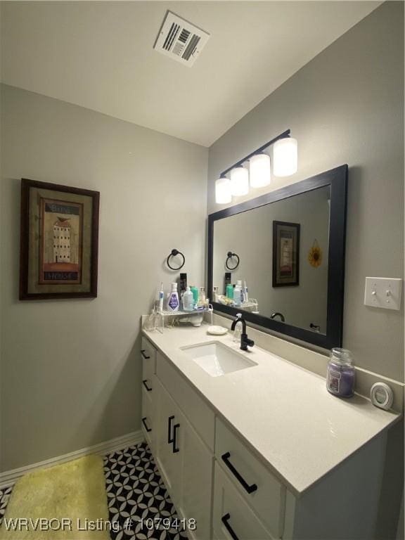 bathroom with visible vents, vanity, and baseboards