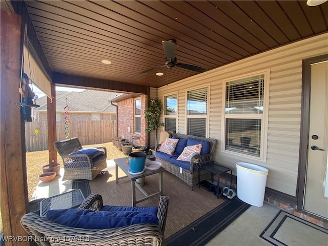 view of patio with a ceiling fan, fence, and an outdoor living space