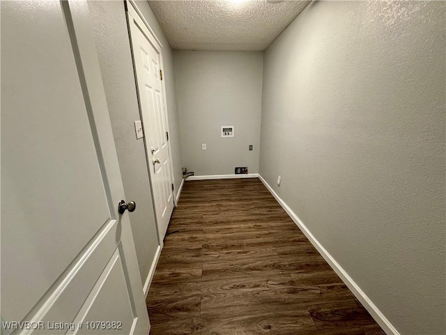 clothes washing area featuring a textured ceiling, laundry area, washer hookup, dark wood-style flooring, and baseboards