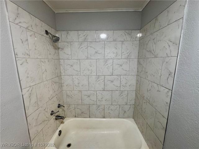 bathroom featuring shower / washtub combination and crown molding