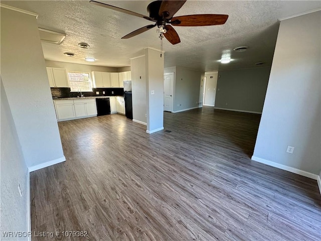 kitchen featuring dark wood-type flooring, a sink, white cabinets, open floor plan, and black appliances