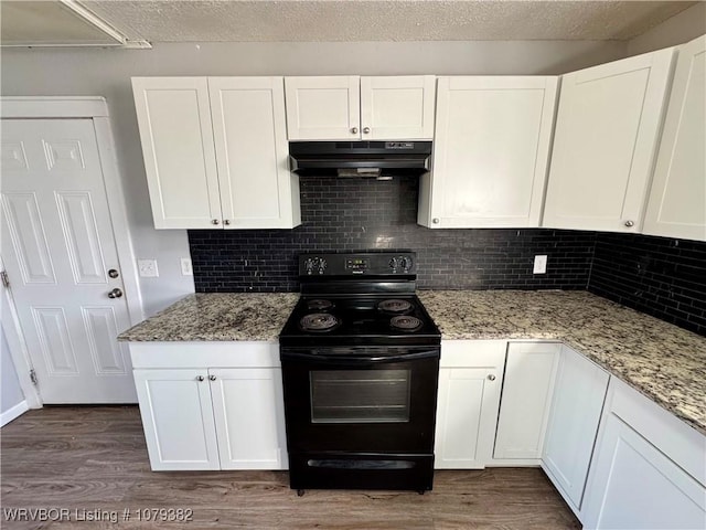 kitchen featuring white cabinets, under cabinet range hood, dark wood finished floors, and black range with electric stovetop